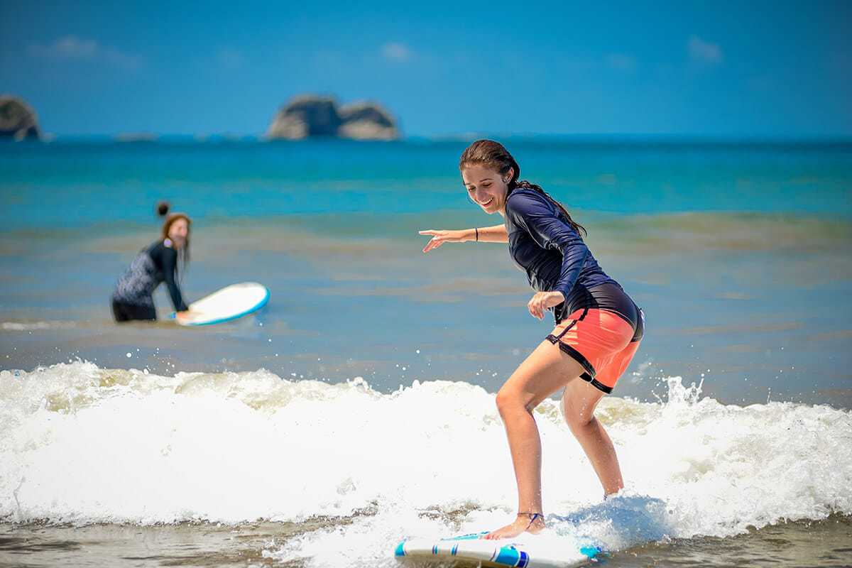 Student surfing. Wilderness and Adventure Therapy for Young Adults. Pure Life in Costa Rica.
